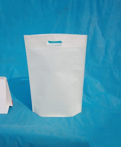 non woven fabric grocery bags on blue background. ECO Friendly Tote promotional products shopper bags